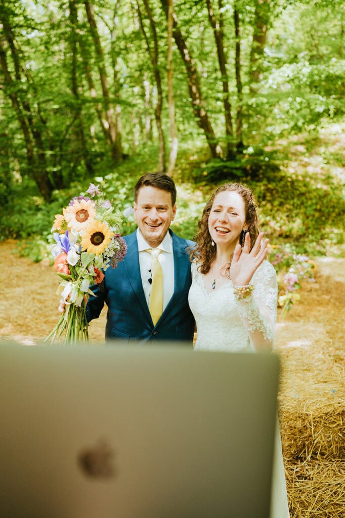 Bride and groom smiling during outdoor wedding.