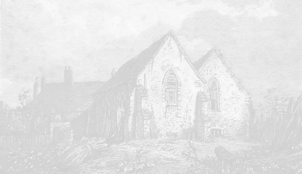 An old, weathered stone building with Gothic architectural features and arched windows, surrounded by overgrown grass and debris. The structure appears partially ruined, with a cloudy sky in the background, reminiscent of the historic Ripple Court Estate in Kent. Image by Pearce Wedding Photography.