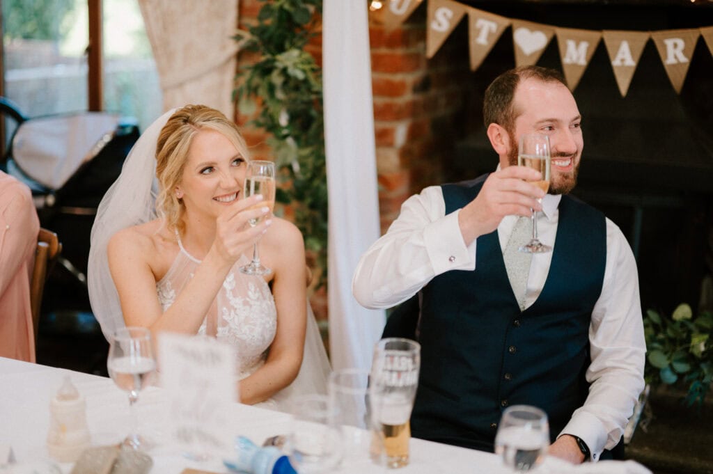 Bride and groom toasting at wedding reception.