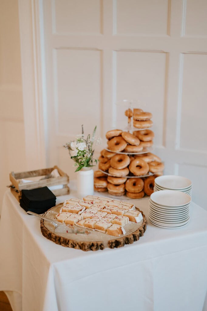 Table with doughnuts and cakes, elegant display.