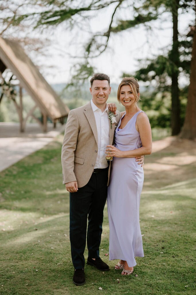 Couple smiling, outdoor event, formal attire