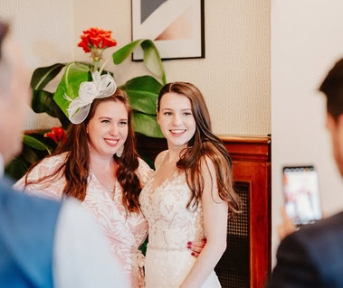 bride and wedding guest pose for a photo