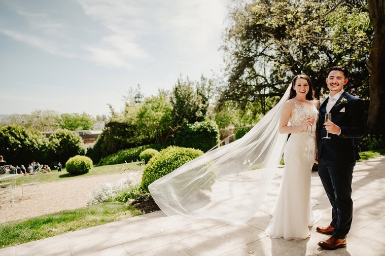 Stunning wedding portrait of bride and groom with the veil being windswept