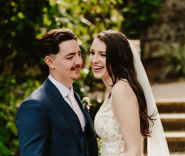 Bride and groom laughing together on their wedding day