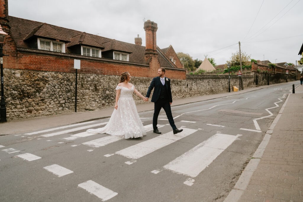 Bride and groom crossing a street.