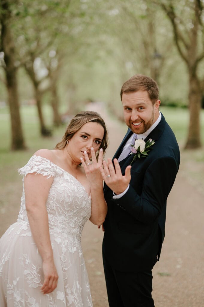 Bride and groom showing wedding rings.