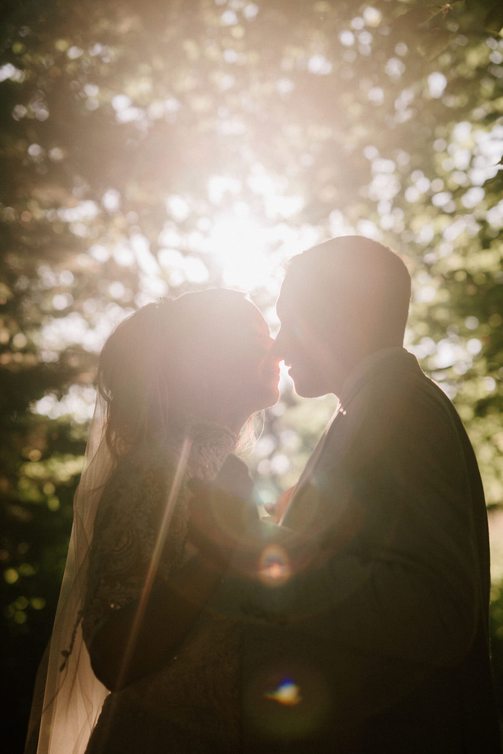 Couple kissing at sunset on their wedding day.
