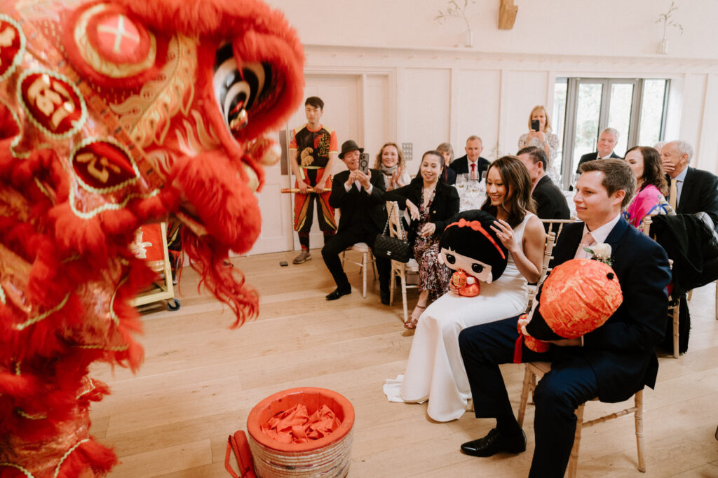 Wedding guests enjoying traditional Chinese lion dance performance