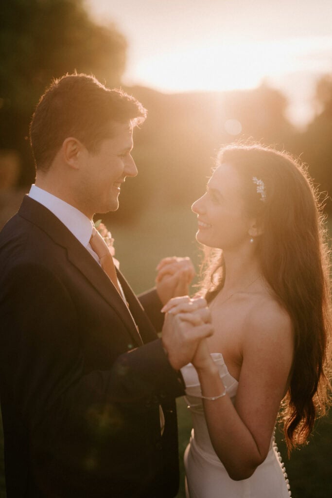 Couple dancing at sunset on wedding day.