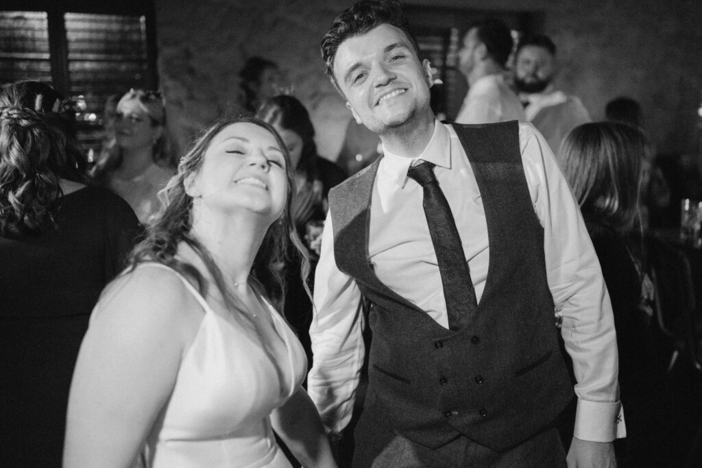 Happy wedding couple smiling at the reception party.