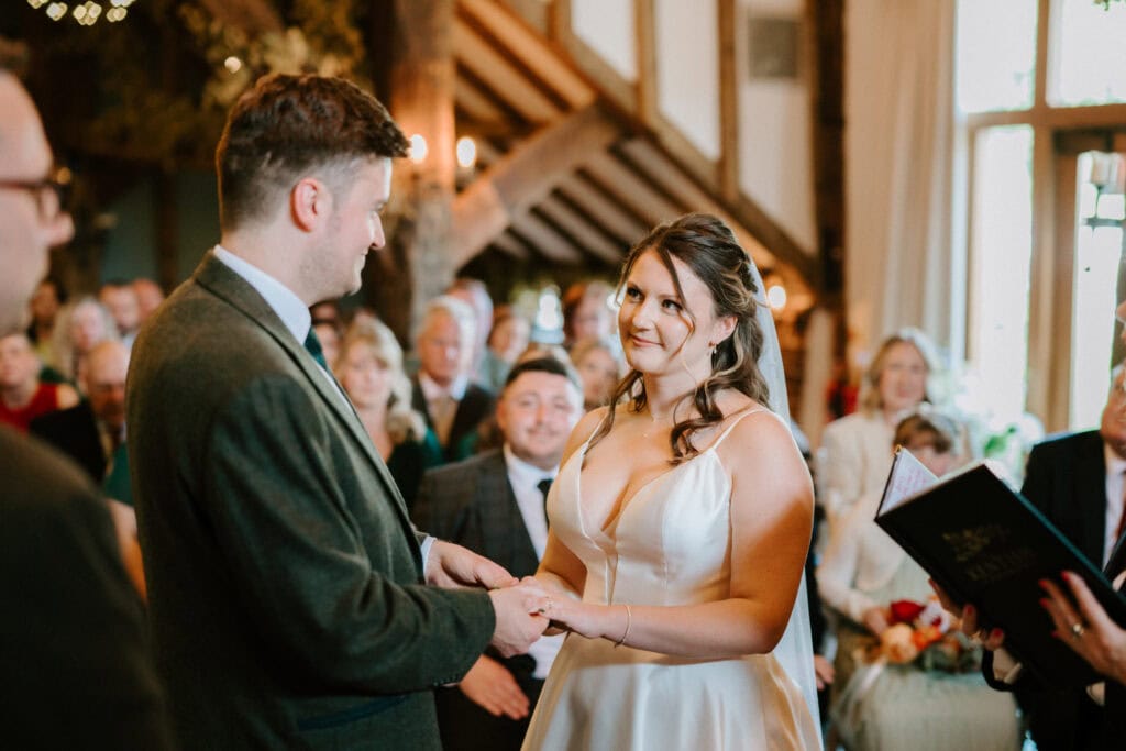 Bride and groom exchanging vows in wedding ceremony.