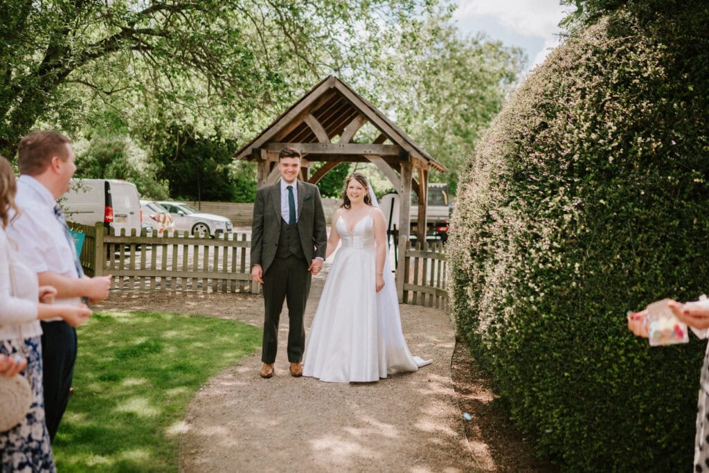 Bride and groom outside at a garden wedding.