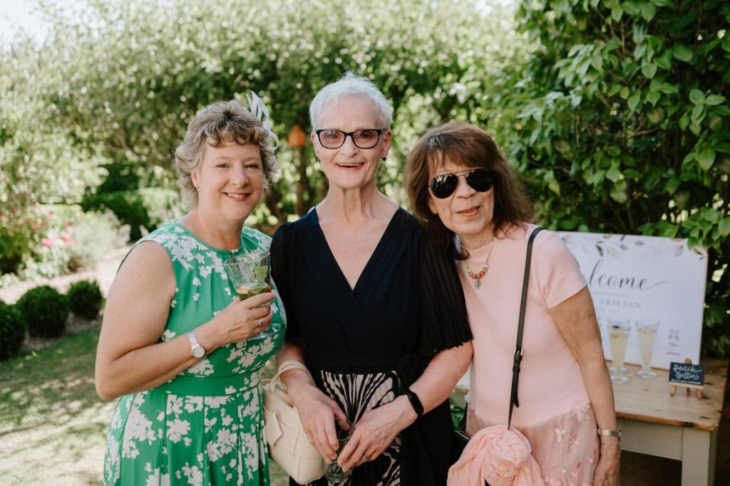 Three women enjoying an outdoor event.
