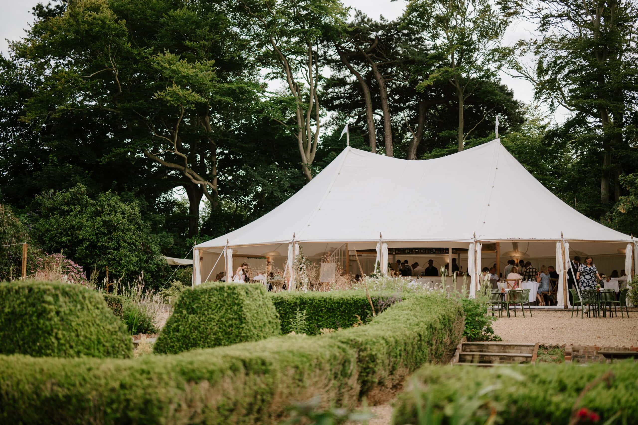 Outdoor wedding reception under white tent