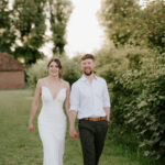 Bride and groom holding hands outdoors
