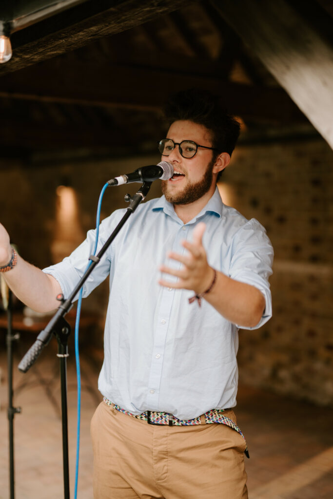 Man singing into a microphone indoors