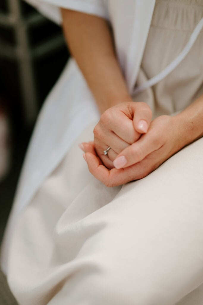 Close-up of a hand with an engagement ring