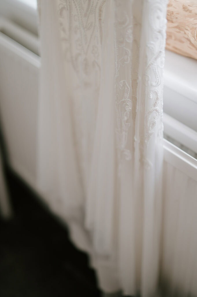Close-up of delicate lace wedding dress.