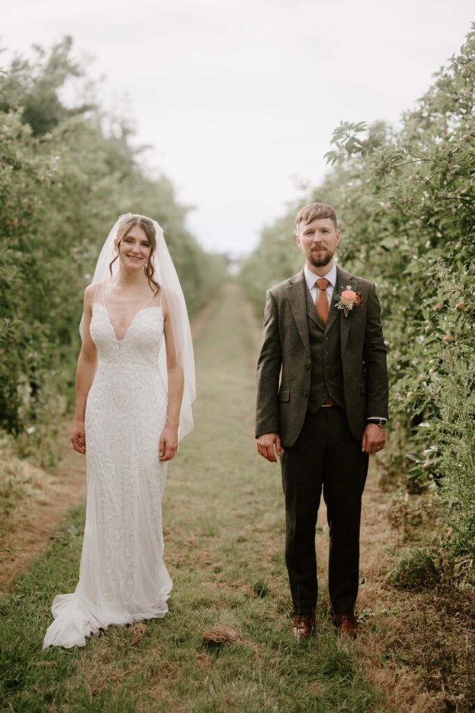 Wedding couple standing in a green garden