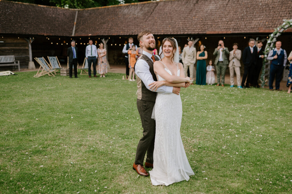Bride and groom dancing at outdoor wedding.