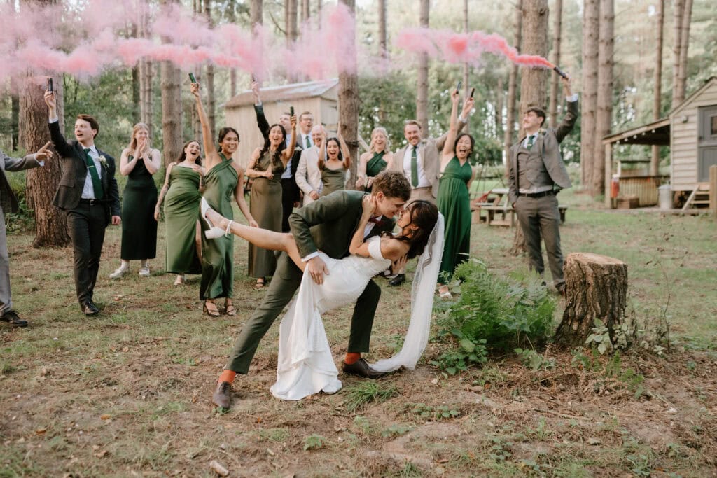 Bride and groom celebrate outdoors with wedding party.