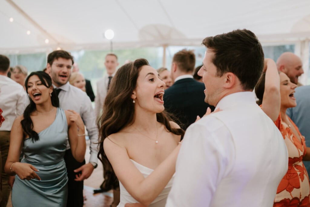 Guests dancing joyfully at a wedding reception