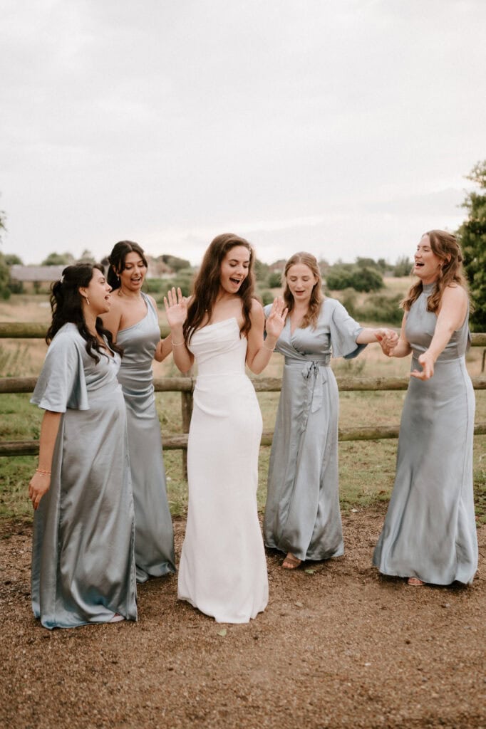 Bridesmaids and bride in countryside celebration.