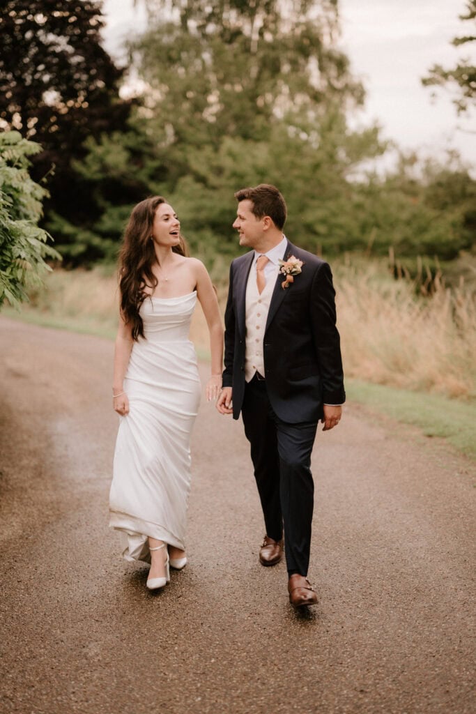 Bride and groom walking happily outdoors