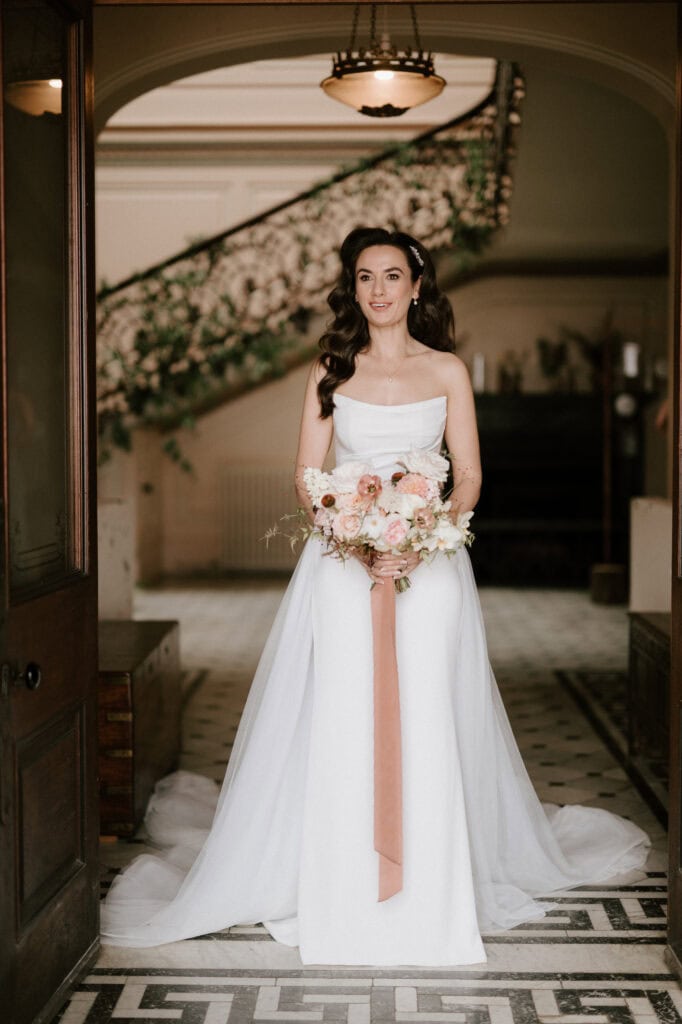 Bride in elegant wedding dress holding bouquet