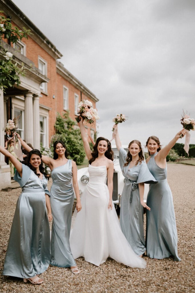 Bride and bridesmaids celebrating outdoors