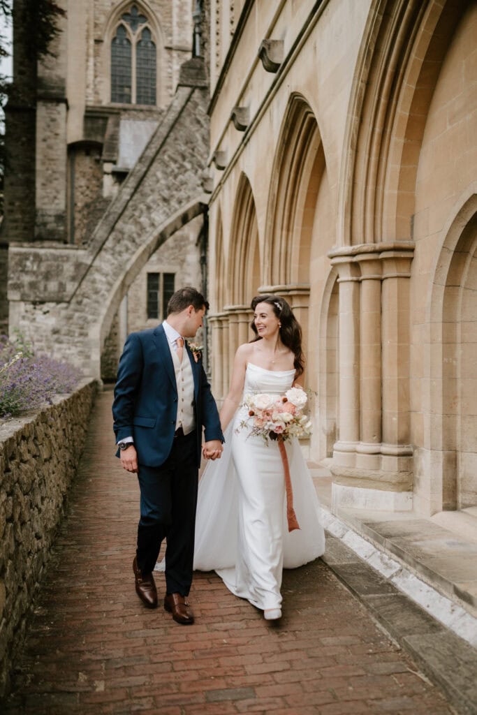 Bride and groom walking outside church