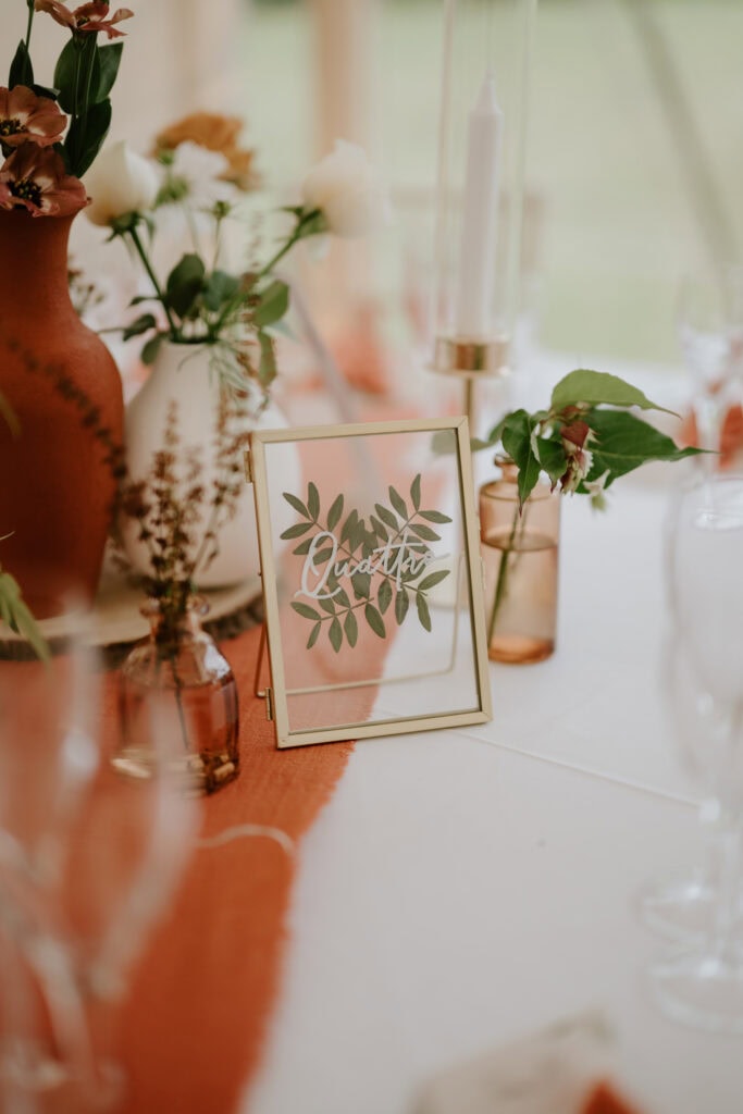 Elegant table decor with earthy tones and greenery.