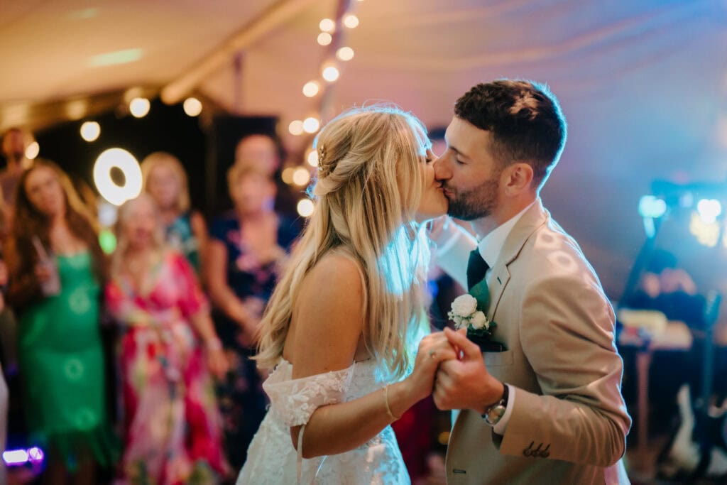 Bride and groom kissing at their wedding reception.