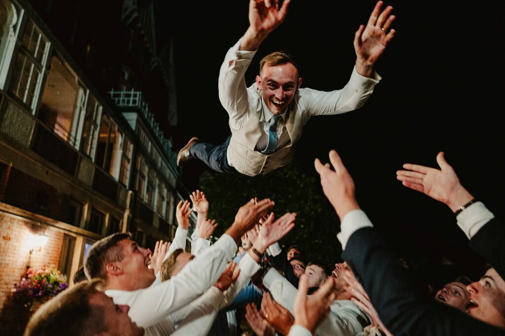 Man joyfully crowd-surfing at night at the yarrow wedding venue in broadstairs