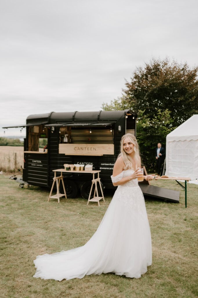 Bride enjoying outdoor wedding by food truck
