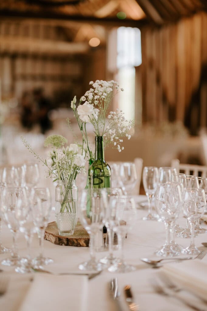 Rustic wedding table with flowers and glassware.