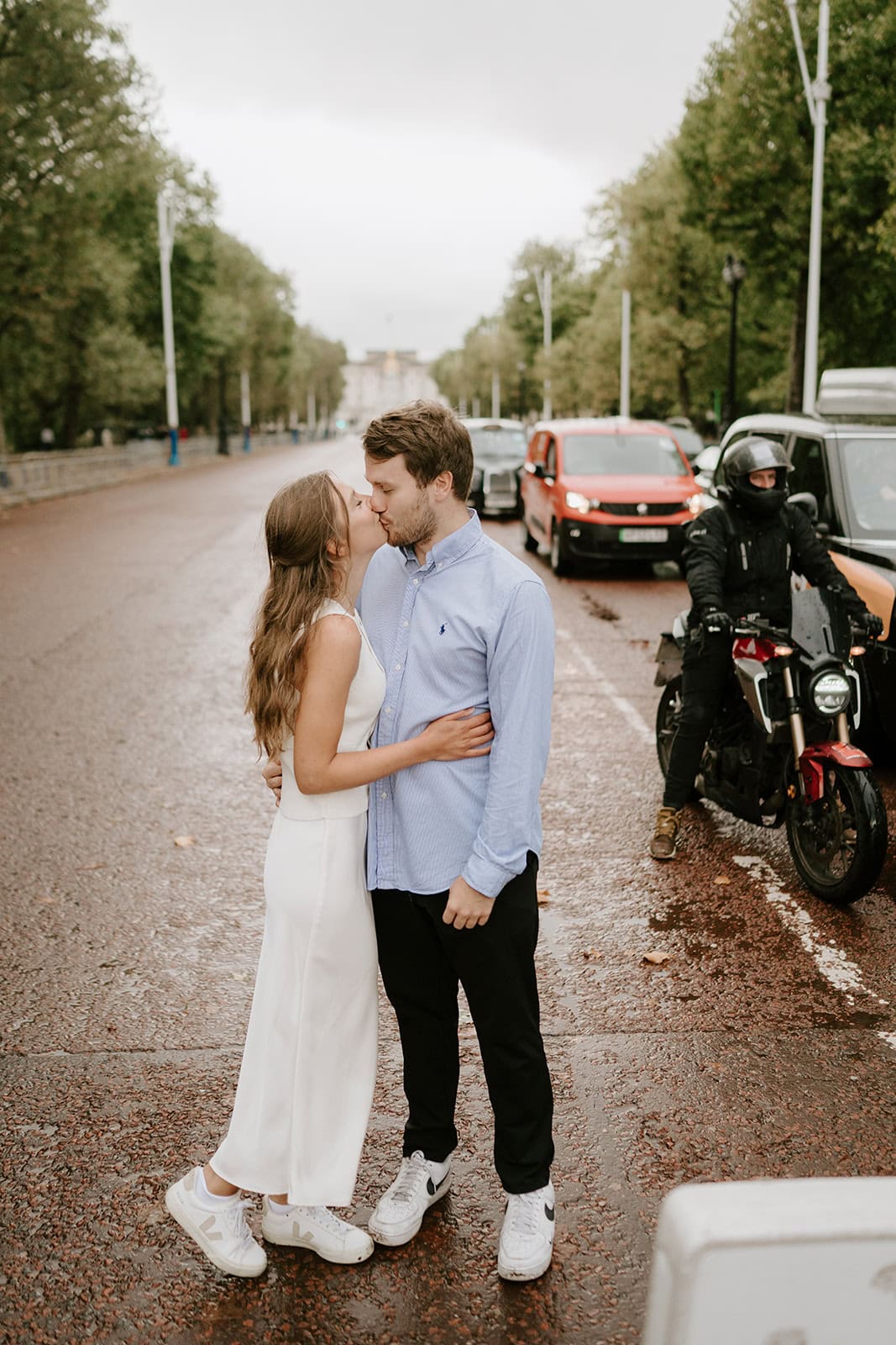 Couple kissing on a city street.