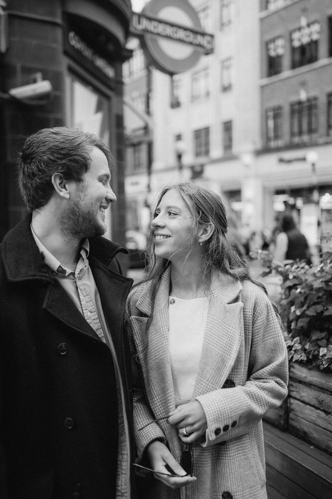Smiling couple near underground station in London