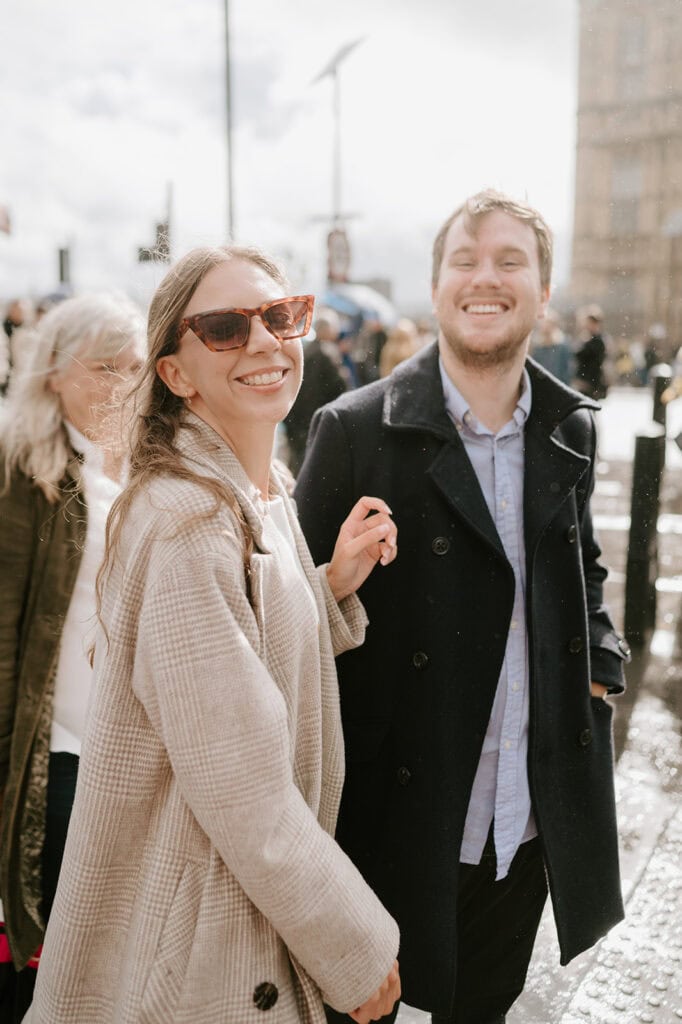 Couple smiling outdoors in sunlight