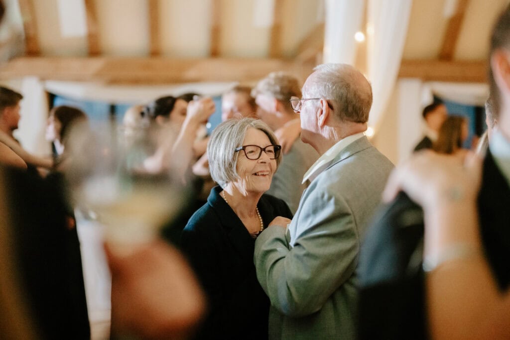 Elderly couple dancing at a lively party.