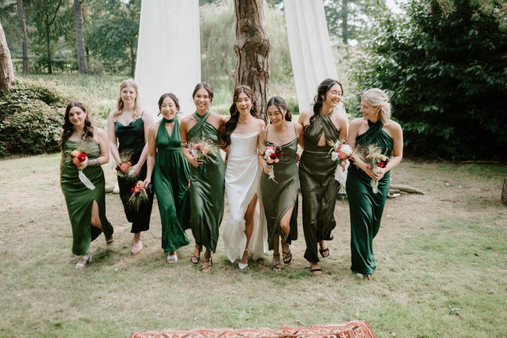 Bridesmaids in green dresses walking outdoors