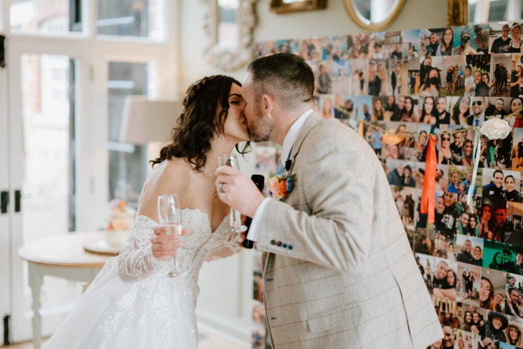 Bride and groom kissing at their wedding reception.