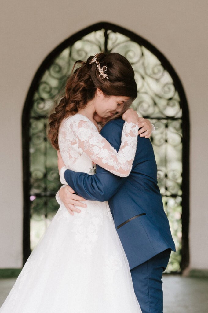 Bride and groom embrace at wedding ceremony.
