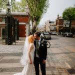 Bride and groom kiss on london city street at the trafalgar tavern