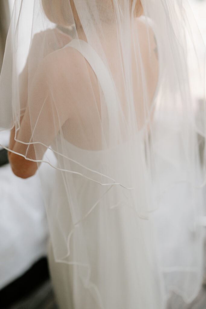 Bride in elegant white dress with veil.