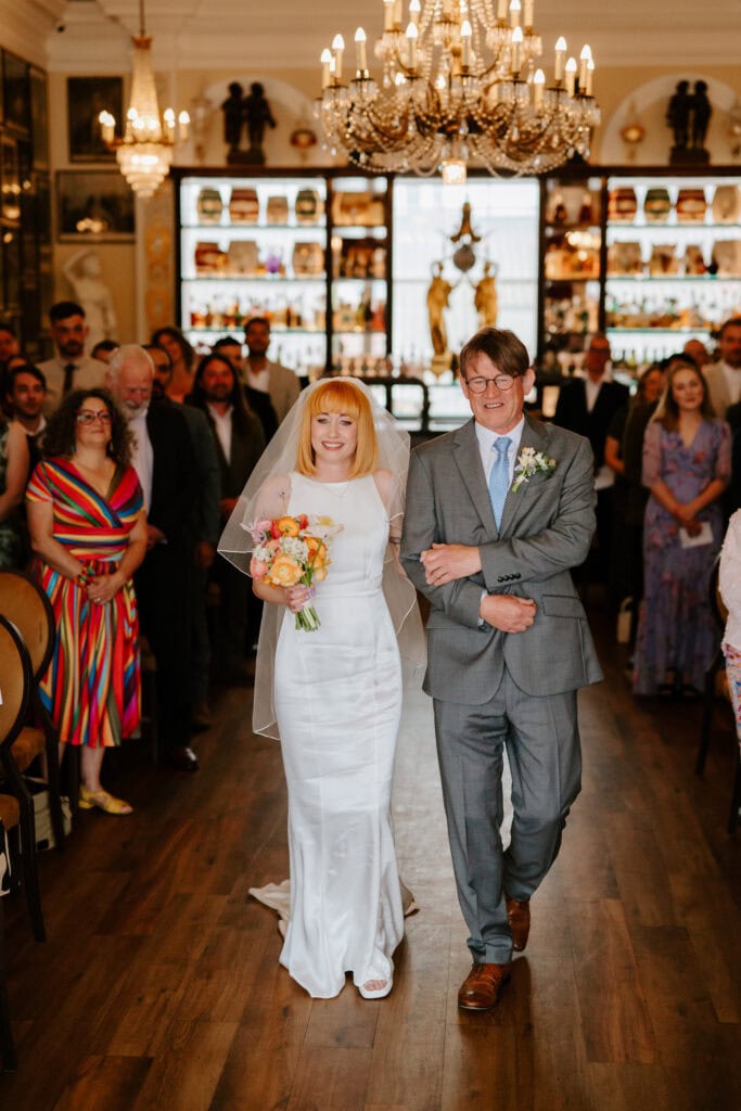 Bride walking down aisle with father, wedding ceremony