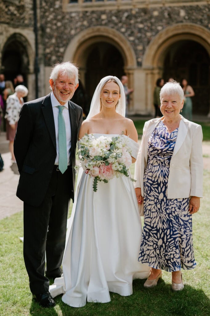 Bride with family at outdoor wedding ceremony
