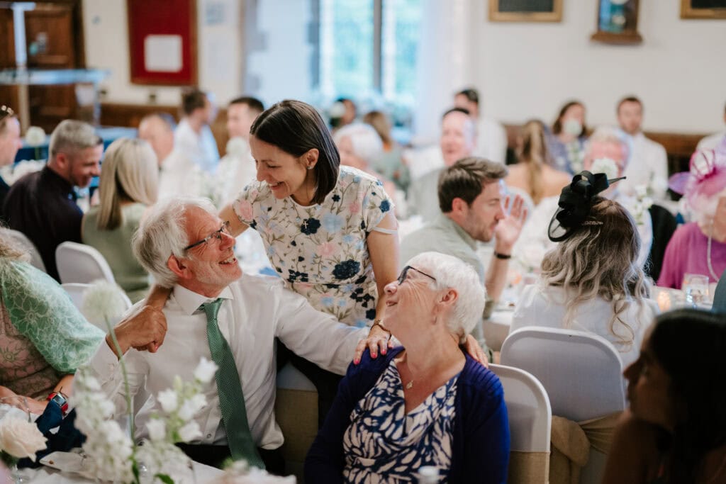 People enjoying a gathering at a banquet table.