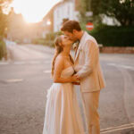 Bride and groom kissing at sunset on canterbury street.