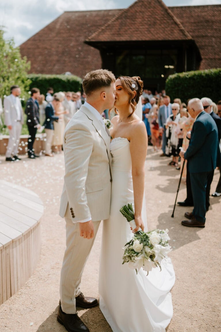 Bride and groom kissing at outdoor wedding